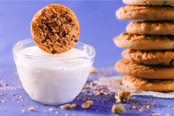 Chip Cookie levitating over milk.