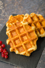 Delicious Belgium waffles on a rustic background 
