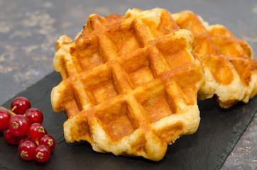 Delicious Belgium waffles on a rustic background 