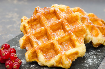 Delicious Belgium waffles on a rustic background 