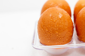 Close up macro at Cold brown Eggs with droplet on white background.