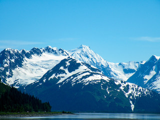 snowy Alaskan mountain range and water panoramic view