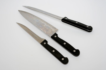 Various kitchen knives with black handle isolated with white background