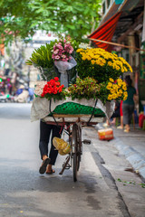 Vietnamese woman selling flowers on a bicycle
