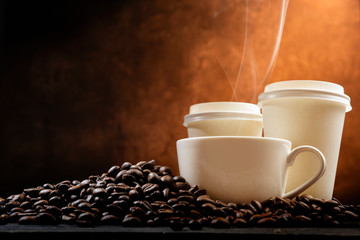 The cup and Styrofoam cup with hot coffee and coffee beans on the table