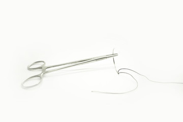 Fototapeta premium Forceps with curved suture needle isolated white background- Image
