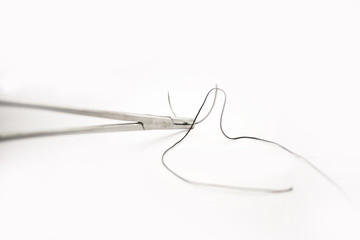 Medical instruments Surgical suture with Forceps on white background. - Image