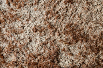 Brown fabric carpet with long pile texture
