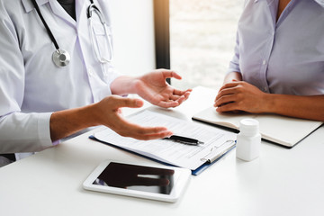 Doctors and patients Consulting about Treatment guidelines at office