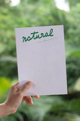 Human hands holding paper note with natural text and natural background.