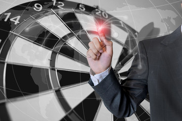 Business man touch social network structure of Digital composite on light  of Midsection with dartboard and globe background. Selective focus on the finger.