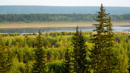North of Vilyuy river in Yakutia in autumn, flows into spruce tundra on a wild overgrown the banks of the marshes