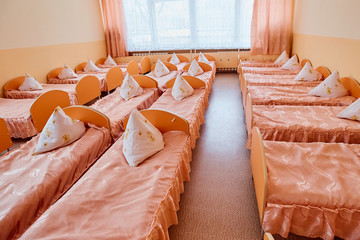 Cots in the kindergarten. Orphanage or boarding school. Beds in a boarding school or in an orphanage
