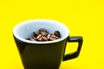 cup with coffee beans and colored paper background