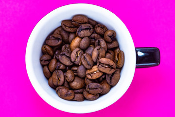 cup with coffee beans and colored paper background