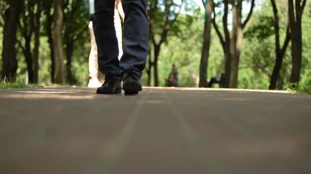 Female returning lost keys to blind man walking alone outdoors, compassion