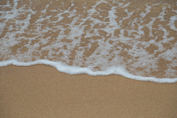 Fototapeta na wymiar Beach sand and ocean waves