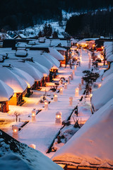 Light up illumination with thatched roof house,  village made of over 30 traditional Japanese houses  and snow covered street in Ouchi Juku village, Fukushima, Tohoku, Japan in Winter