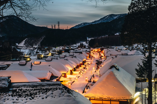 Light up illumination with thatched roof house,  village made of over 30 traditional Japanese houses  and snow covered street in Ouchi Juku village, Fukushima, Tohoku, Japan in Winter