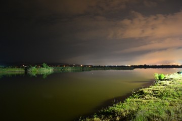 the shore of a lake illuminated at night