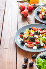 Obraz na płótnie Canvas Greek salad with fresh tomatoes, peppers and cucumbers