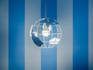 Modern global earth world shape ceiling lamp on white and blue wall background