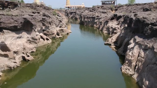 Aerial drone footage of a river with potholes - At Nighoj near Pune and is famous for the naturally created potholes (tinajas) on the riverbed of the Kukadi River