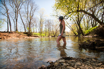 Girl walking through creek in Kentucky