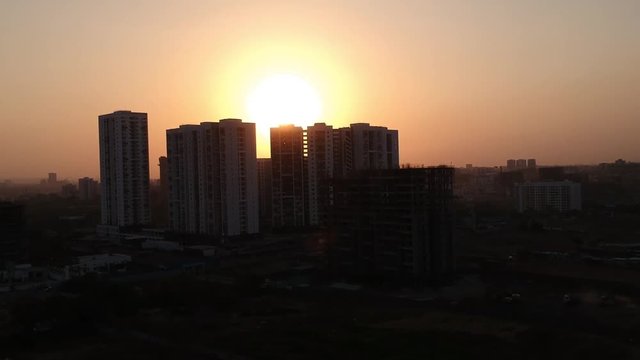 Aerial footage shot in a growing Indian city showcasing architectural buildings as well as new residential apartments.