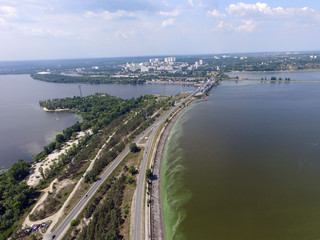 Fototapeta premium Green algae on the surface of the water. blooming water as a consequence of the dam structure and environmental pollution. Storage pool of power station. (drone image). Kiev ,Ukraine
