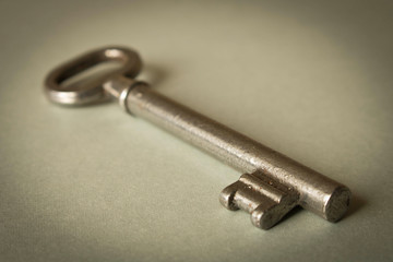 Old key on grey background. Key isolated on grey background.