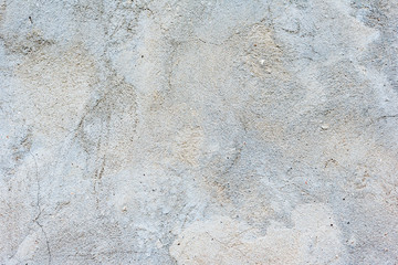 Texture of a concrete wall with cracks and scratches which can be used as a background