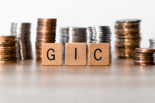 GIC (Guaranteed Investment Certificate) signs with coins in the background