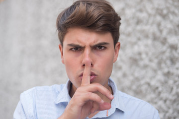 man asking for silence and order with shhh hand sign
