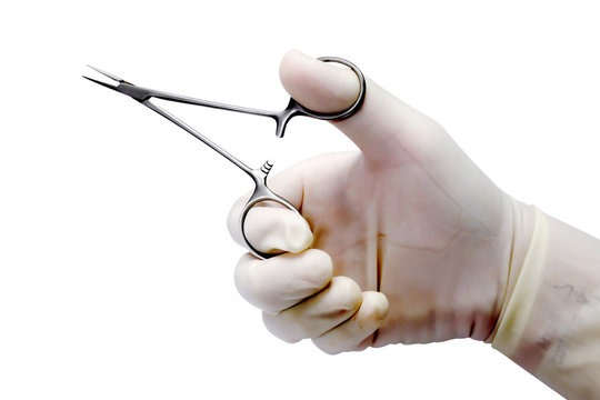 Doctor's hand  in the medical latex glove holding medical artery clamp scissor and shows the gesture of holding the scissors isolate on white background and make with path.