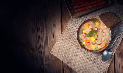 rustic sauerkraut soup with bacon and sausage