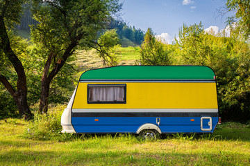 A car trailer, a motor home, painted in the national flag of Gabon stands parked in a mountainous....