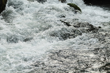 water splashing over rocks