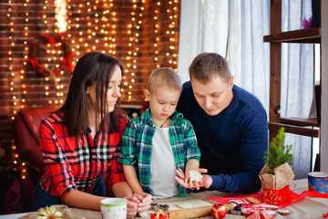 Fototapeta premium happy family prepares Christmas cookies for Christmas