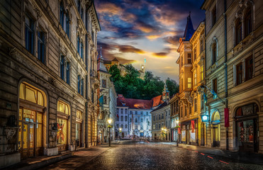 Fototapeta na wymiar View of the street Stritarjeva, evening city and Ljubljana's castle. Ljubljana, capital of Slovenia.