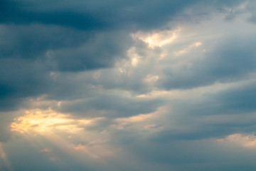 Dramatic picturesque colorful skies with cloud and picturesque sunbeams before sunset