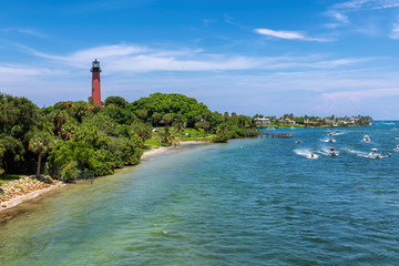 Beautiful view of the Jupiter lighthouse and boats on the sea in Palm Beach County, Florida. © lucky-photo