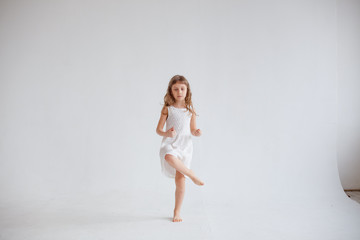 girl in white dress dancing on white background