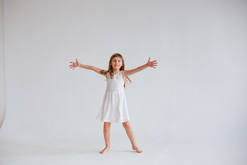 Obraz premium girl in white dress dancing on white background