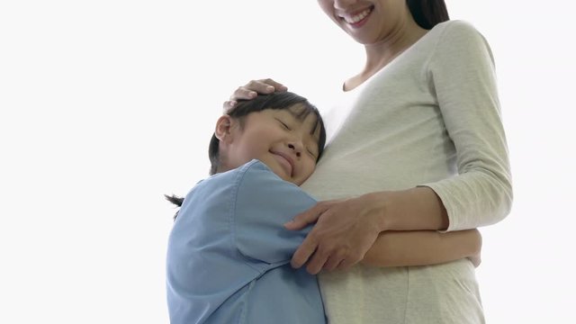 Asian family daughter hug and listening sound flex in pregnant mother belly. Children flex in the stomach. Concept of family, hope and new born.