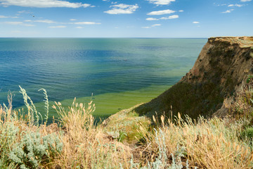 Wild sea coast, wave and hill - beautiful summer landscape and travel concept, bright day and sky with clouds