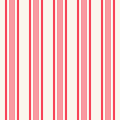 Abstract seamless pattern of vertical red bright stripes.
