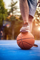 Man making a pause with basketball ball on the urban city court.