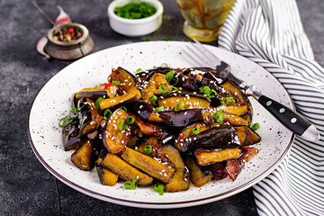 Hot spicy stew eggplant in Korean style with green onion. Aubergine saute. Vegan food.