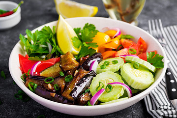 Salad fresh raw vegetables - armenian cucumber, tomatoes, paprika, parsley, red onion and stewed eggplant. Vegan buddha bowl.